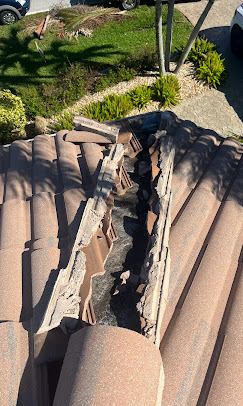 Wide view of multi-tile damage on Florida tile roof