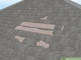 Multiple missing shingle tabs leaving bare roof deck exposed
